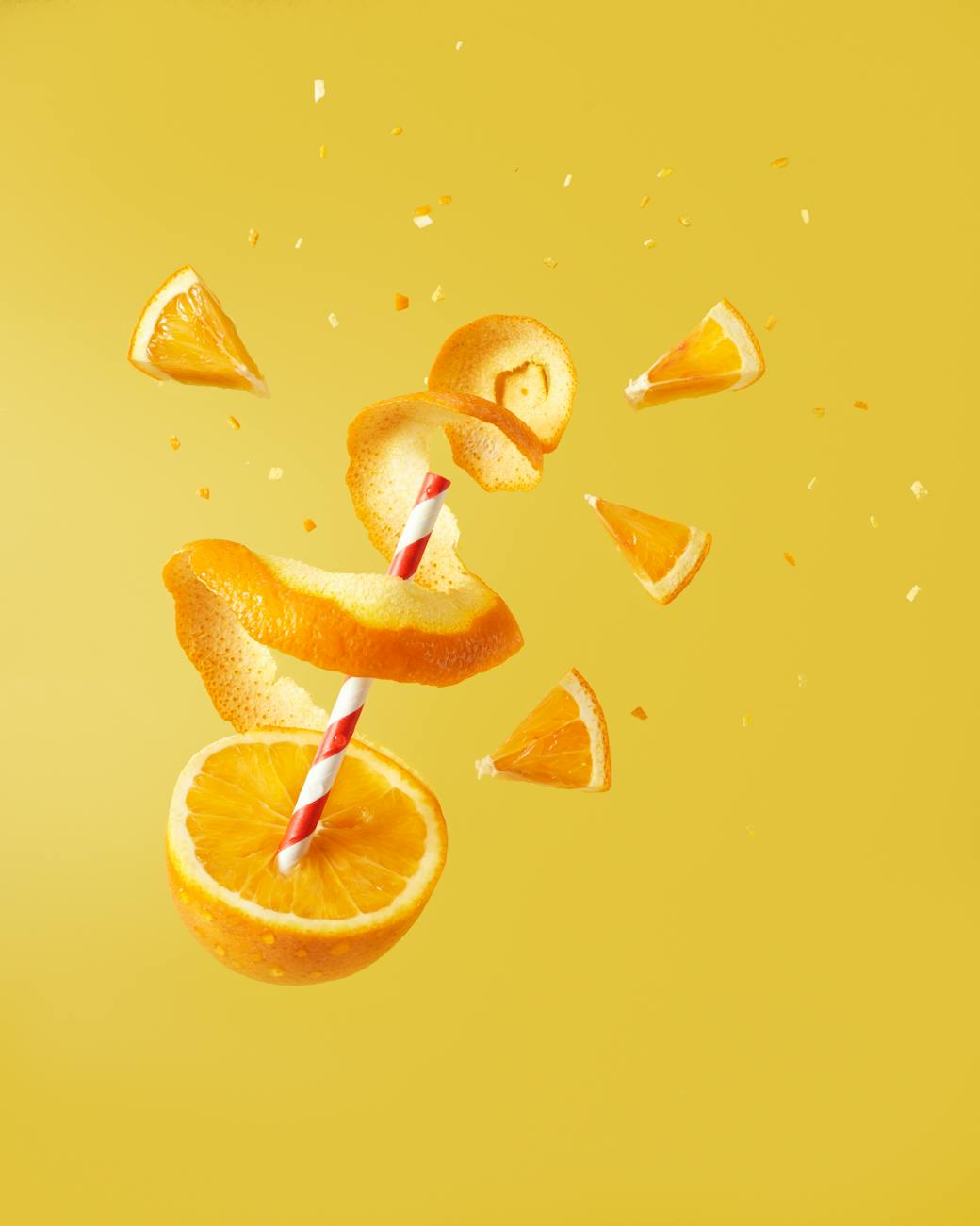sliced orange fruit on yellow background
